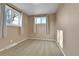 This bedroom features neutral walls, carpet, two windows, and curtains at 611 Winona Ct, Denver, CO 80204