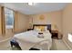 A warm bedroom features a comfortable queen-sized bed with decorative pillows and matching nightstands and lamps at 611 Winona Ct, Denver, CO 80204