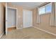 A bedroom featuring neutral walls, carpet, closet, and a door to another room at 611 Winona Ct, Denver, CO 80204