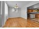Bright dining area featuring wood floors and contemporary lighting fixtures at 611 Winona Ct, Denver, CO 80204