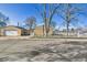 A well-maintained single-Gathering home boasts a large, detached garage and a secure fenced yard at 611 Winona Ct, Denver, CO 80204