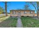 Charming single-story brick home with a well-maintained lawn and inviting front entrance at 611 Winona Ct, Denver, CO 80204