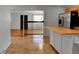 View of kitchen from the dining room with stainless steel appliances, tile floors and modern lighting at 611 Winona Ct, Denver, CO 80204