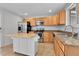 Modern kitchen features stainless steel appliances, a tile backsplash, and a central island at 611 Winona Ct, Denver, CO 80204