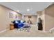 Finished basement featuring a blue sofa, coffee table, and decor at 611 Winona Ct, Denver, CO 80204