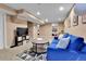 Finished basement featuring a blue sofa, coffee table, and a television at 611 Winona Ct, Denver, CO 80204