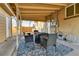 A covered patio is furnished with a dining table, chairs, and an outdoor rug at 611 Winona Ct, Denver, CO 80204
