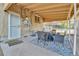 A covered patio is furnished with a dining table, chairs, and an outdoor rug at 611 Winona Ct, Denver, CO 80204