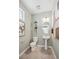 Cozy half-bathroom with pedestal sink, toilet, decorative plants, and modern artwork at 924 Andrews Crest Dr, Berthoud, CO 80513