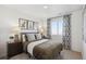 Bedroom featuring a queen bed, patterned curtains, and artwork at 924 Andrews Crest Dr, Berthoud, CO 80513
