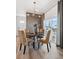 Cozy dining area featuring modern light fixture, a decorative wall, and sliding door to balcony at 924 Andrews Crest Dr, Berthoud, CO 80513