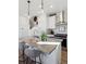 Stylish kitchen island featuring bar stool seating, elegant pendant lighting, and modern appliances at 924 Andrews Crest Dr, Berthoud, CO 80513