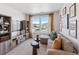 Living room with sectional sofa, side tables, large windows, and media center at 924 Andrews Crest Dr, Berthoud, CO 80513