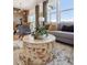 Cozy living area with natural light, comfortable seating, and a decorative, round wood table at 924 Andrews Crest Dr, Berthoud, CO 80513