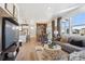 Open-concept living space seamlessly connects living room, dining area, and modern kitchen at 924 Andrews Crest Dr, Berthoud, CO 80513