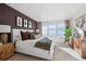 Modern main bedroom with large windows offering lots of natural light and stylish furniture at 924 Andrews Crest Dr, Berthoud, CO 80513