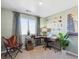Comfortable home office with stylish desk, decor, ample natural light, and leather chair at 924 Andrews Crest Dr, Berthoud, CO 80513
