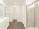 Bright bathroom featuring a glass shower, double doors, and modern finishes at 1935 Coolidge Way, Aurora, CO 80018
