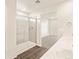 Bathroom showcasing a glass shower, gray tile, and double sinks on a white countertop at 1935 Coolidge Way, Aurora, CO 80018