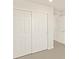 Spacious bedroom featuring sliding closet doors and a door leading into the hallway at 1935 Coolidge Way, Aurora, CO 80018