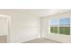 Bright bedroom with a large window, plush carpeting, and a calming, neutral color palette at 1935 Coolidge Way, Aurora, CO 80018
