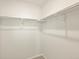 Bright walk-in closet offering shelving with metal rods for hanging clothes at 1935 Coolidge Way, Aurora, CO 80018