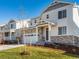 Exterior view of a two-story home with stone accents and well-maintained lawn at 1935 Coolidge Way, Aurora, CO 80018