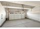 Two-car garage with concrete floor and white door with window row at 1935 Coolidge Way, Aurora, CO 80018