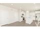 Bright, open-concept kitchen features white cabinetry, stainless steel appliances, and a center island at 1935 Coolidge Way, Aurora, CO 80018