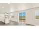 Open floorplan with bright white walls, wood look floors and a large glass sliding door at 1935 Coolidge Way, Aurora, CO 80018