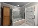 A bathroom featuring a glass block partition, tile walls, tile floors and a tub shower at 241 N Grant St, Denver, CO 80203