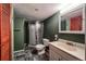 A bathroom featuring a stand up shower, tile floors and dark green walls at 241 N Grant St, Denver, CO 80203