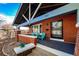 Inviting front porch with red brick, security door, and chairs for relaxing on a sunny day at 241 N Grant St, Denver, CO 80203