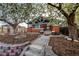 Charming brick home featuring a landscaped front yard, stone walkway, and flowering trees at 241 N Grant St, Denver, CO 80203