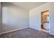 Bedroom with plush carpeting, access to an ensuite bathroom, and ample natural light at 15530 W 64Th Pl # C, Arvada, CO 80007