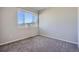 Bedroom featuring a large window providing natural light and neutral carpeting at 15530 W 64Th Pl # C, Arvada, CO 80007