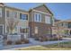 Charming two-story townhome with brick accents, inviting entrance and manicured lawn at 15530 W 64Th Pl # C, Arvada, CO 80007