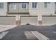 Three-car garage with concrete driveway, attached to a townhome at 15530 W 64Th Pl # C, Arvada, CO 80007