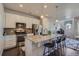 Bright kitchen showcasing an island with barstool seating and pendant lighting at 15530 W 64Th Pl # C, Arvada, CO 80007