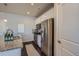 Modern eat-in kitchen boasts stainless steel appliances, white cabinetry, and hardwood floors at 15530 W 64Th Pl # C, Arvada, CO 80007