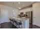 Modern eat-in kitchen boasts stainless steel appliances, white cabinetry, and a granite-topped island at 15530 W 64Th Pl # C, Arvada, CO 80007