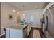 Modern eat-in kitchen boasts stainless steel appliances, a granite-topped island, and hardwood floors at 15530 W 64Th Pl # C, Arvada, CO 80007