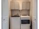 Laundry room with washer, dryer, and overhead storage cabinets at 15530 W 64Th Pl # C, Arvada, CO 80007