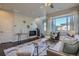 Bright living room boasts hardwood floors, sleek furniture, fireplace, and a large window at 15530 W 64Th Pl # C, Arvada, CO 80007