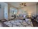 Cozy living room filled with natural light, stylish furnishings and a ceiling fan at 15530 W 64Th Pl # C, Arvada, CO 80007
