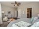 Bright main bedroom features a ceiling fan, carpeted floor, and access to a bathroom at 15530 W 64Th Pl # C, Arvada, CO 80007