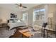 Bright main bedroom with carpet, neutral decor, ceiling fan and lots of natural light at 15530 W 64Th Pl # C, Arvada, CO 80007