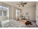 Bright main bedroom has a ceiling fan, comfortable seating, and large windows at 15530 W 64Th Pl # C, Arvada, CO 80007