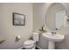 Cozy powder room with a modern sink, toilet, and mirror at 15530 W 64Th Pl # C, Arvada, CO 80007