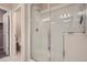 Enclosed tile shower featuring a rainfall showerhead and sleek glass door at 15530 W 64Th Pl # C, Arvada, CO 80007